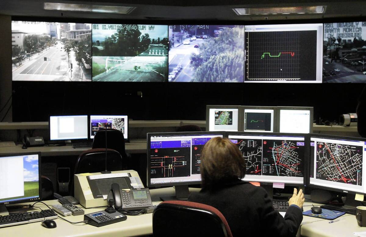 City engineers keep an eye on congestion at the traffic surveillance center under the City Hall annex. All L.A. signals are now under central control.