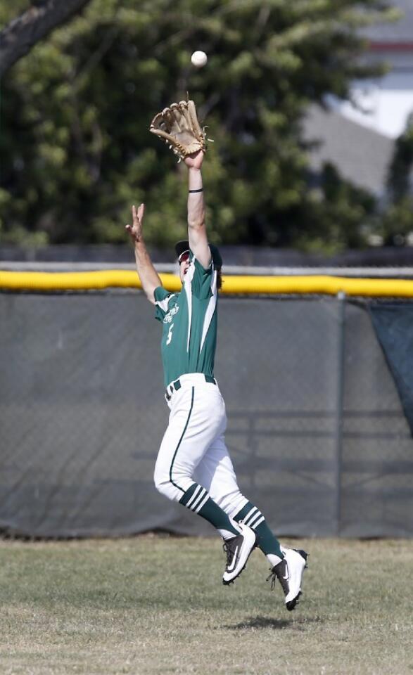 Costa Mesa High's Grady Conner makes a leaping catch on a fly ball in the second inning against Estancia.