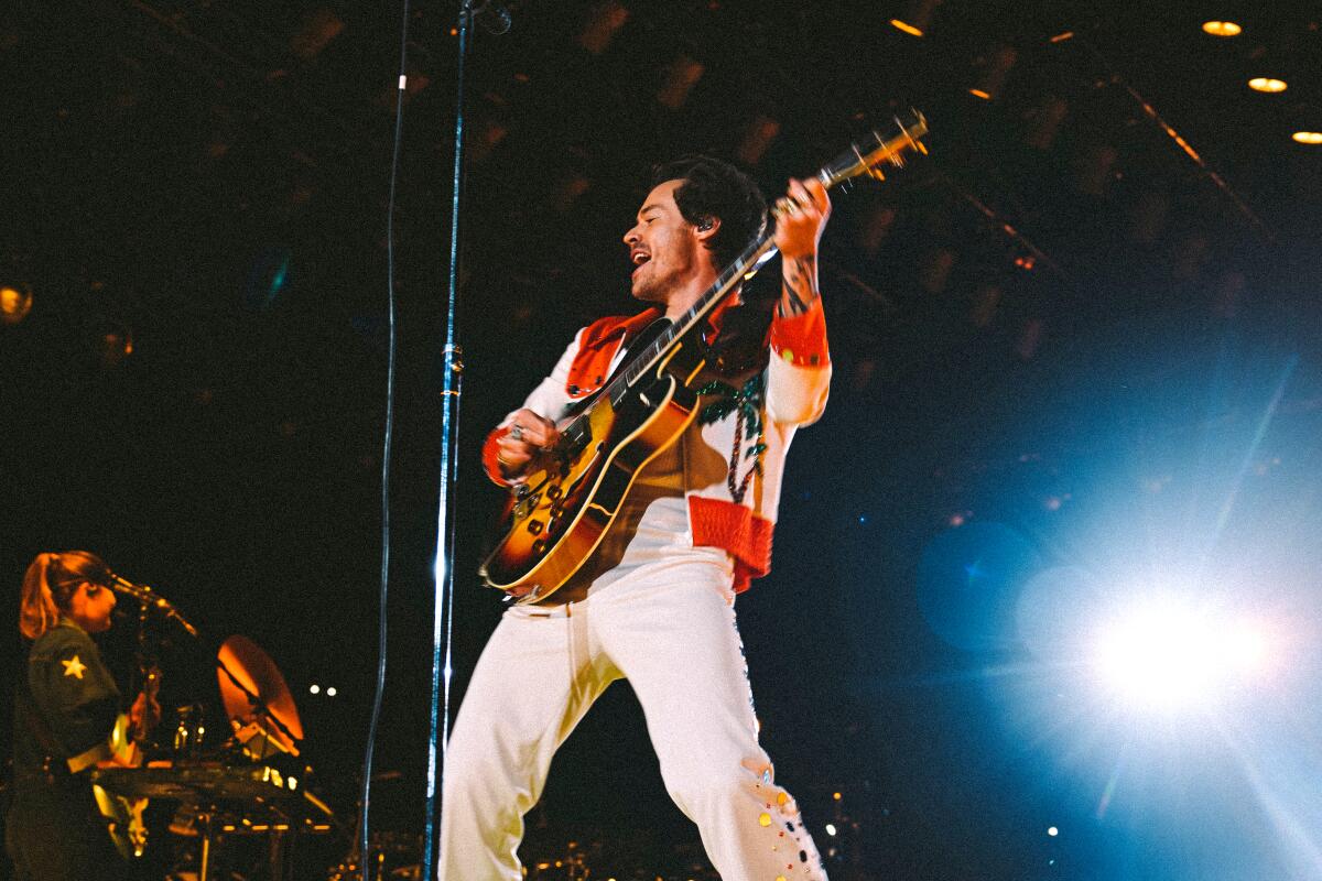 A man playing guitar on a stage