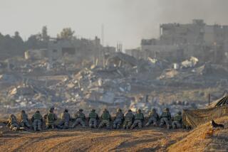 Israeli soldiers take positions near the Gaza Strip border, in southern Israel, Monday, Dec. 11, 2023. The army is battling Palestinian militants across Gaza in the war ignited by Hamas' Oct. 7 attack into Israel. (AP Photo/Ohad Zwigenberg)
