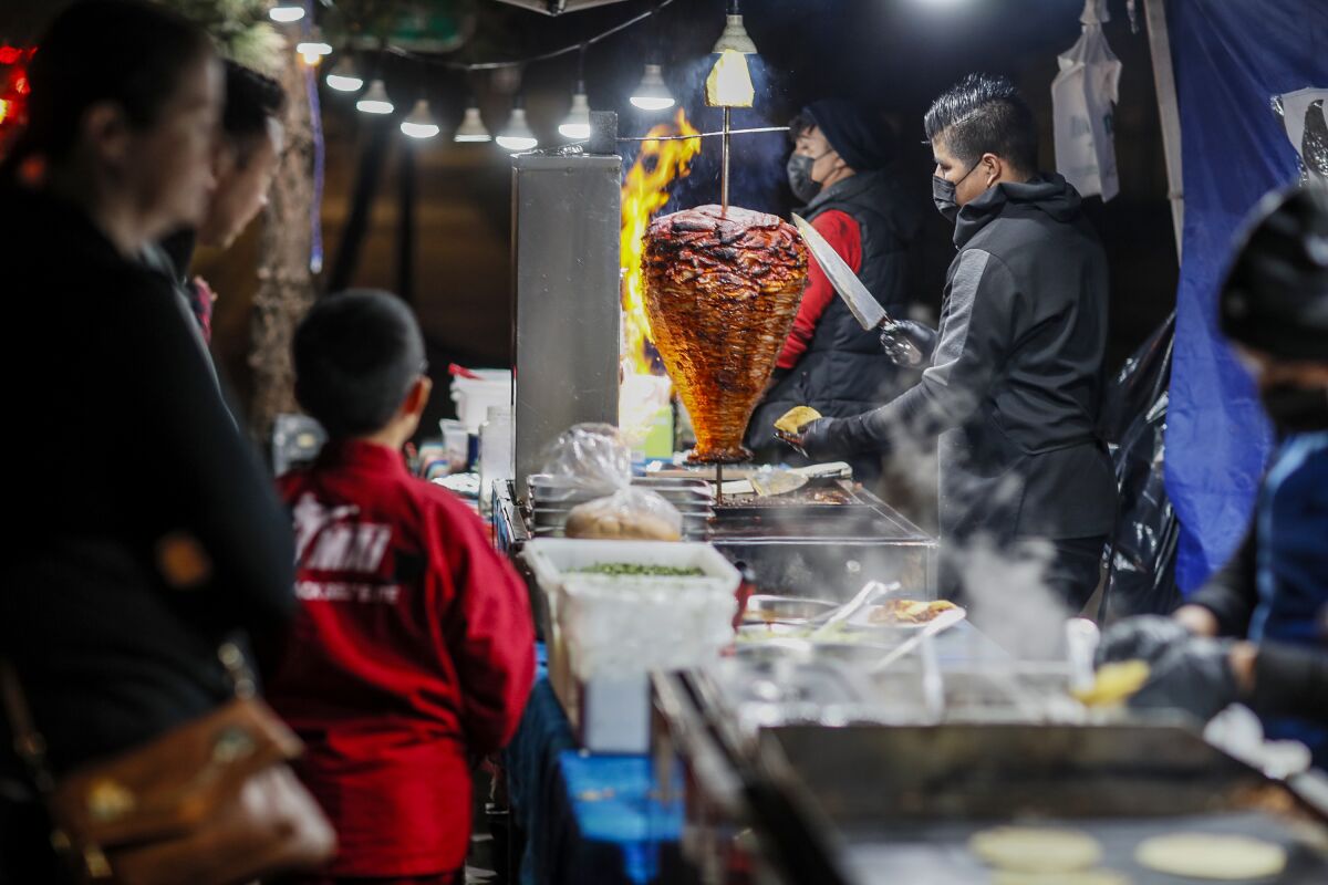 Customers line up at Tacos El Chivo on North Lakeview Avenue in Anaheim.