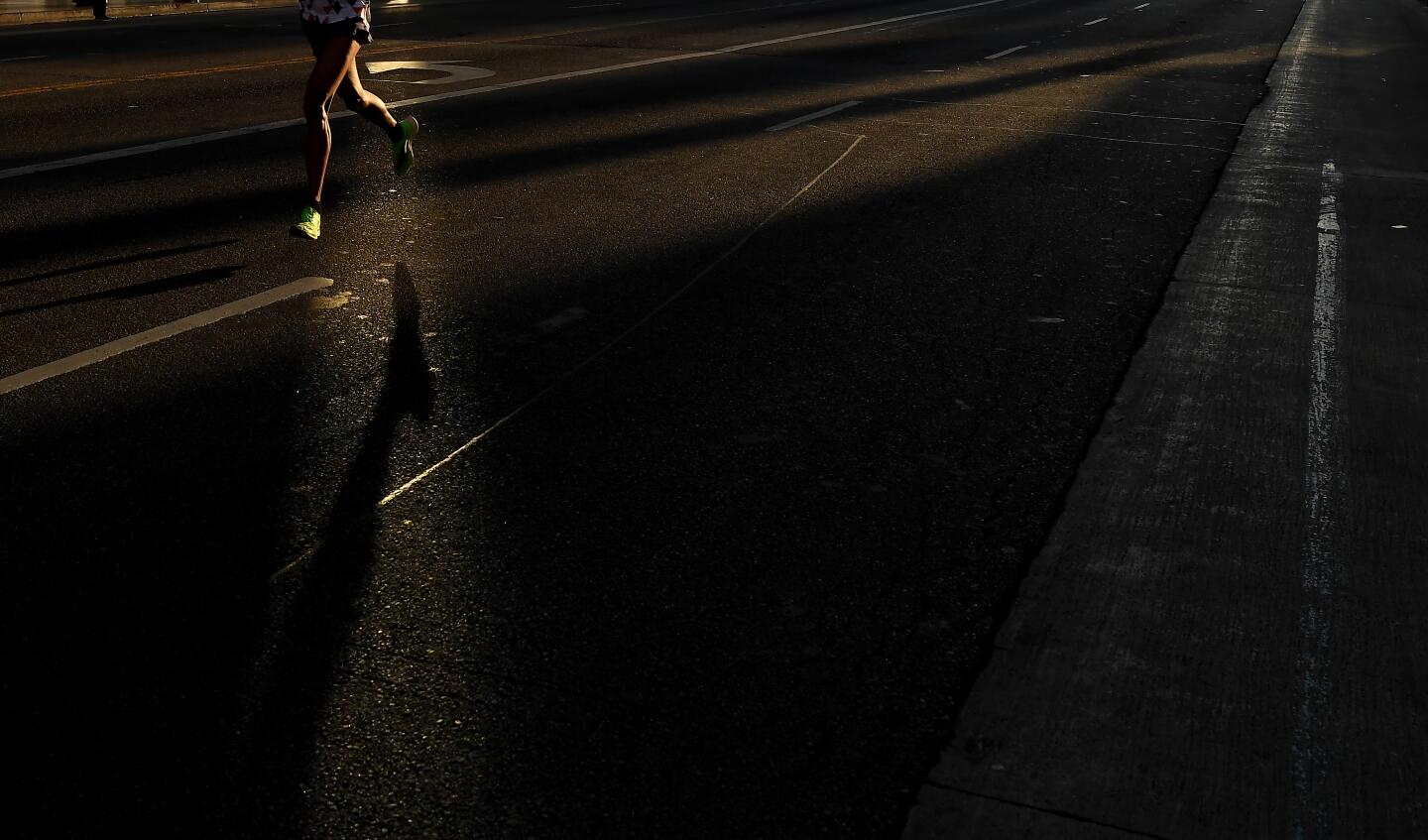 Runners jog along Hollywood Blvd. in Hollywood Sunday during L.A. Marathon.