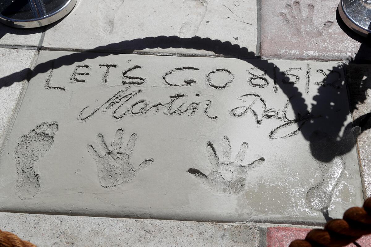 Martin Daly's cement slab includes the message, "Let's Go" during the 25th anniversary Surfers' Hall of Fame ceremony Friday.