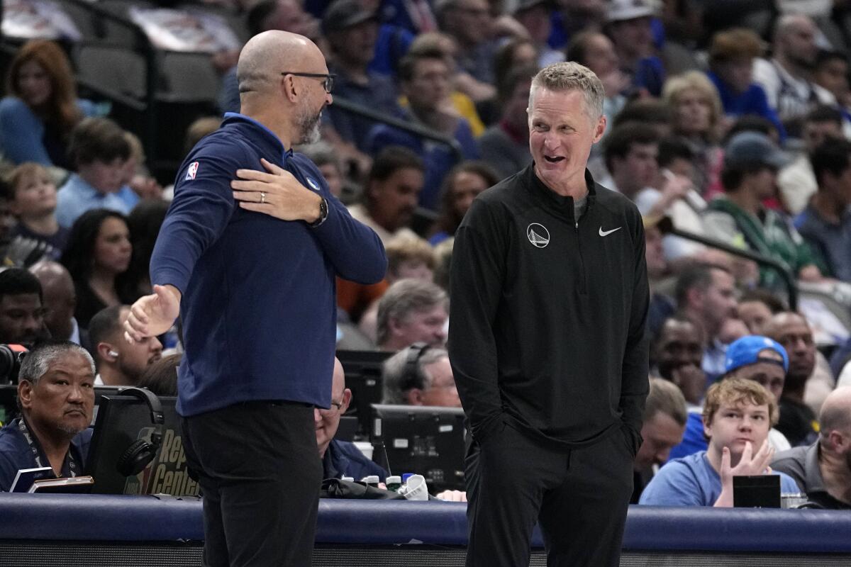 Coaches Jason Kidd, left, of Dallas and Steve Kerr of Golden State chat along the sideline during a game in 2023.
