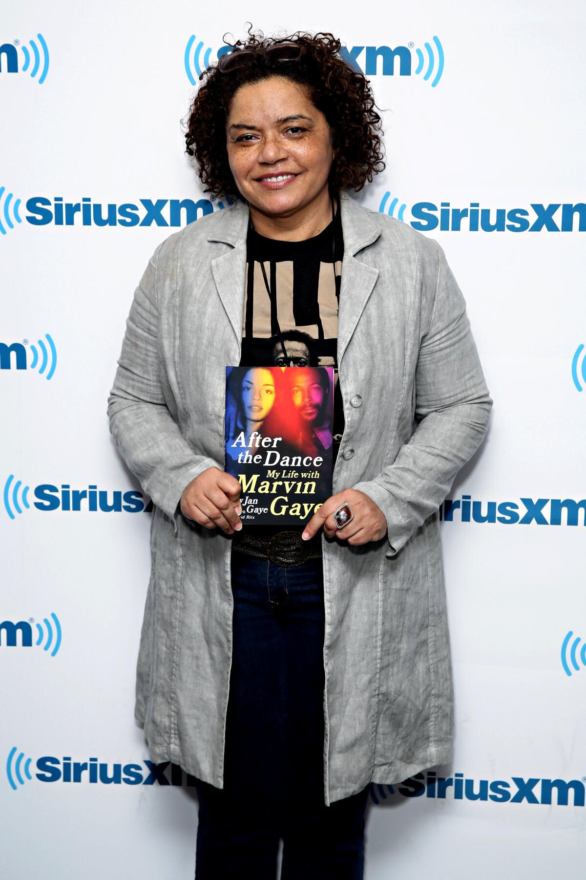 A woman holds a copy of her autiobiography