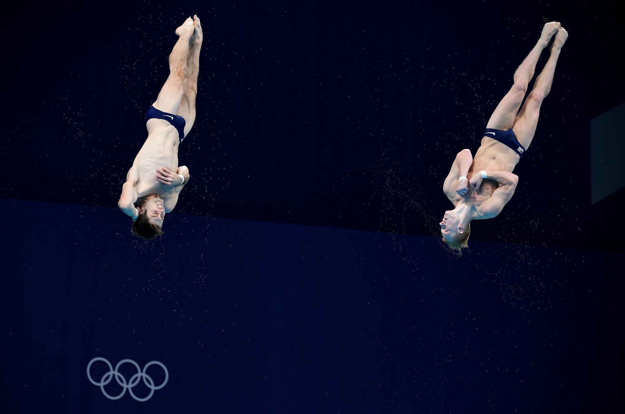 Two divers in midair. 