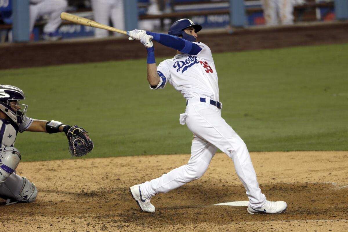The Dodgers' Cody Bellinger follows through on his game-winning home run in the ninth inning Aug. 22, 2020.