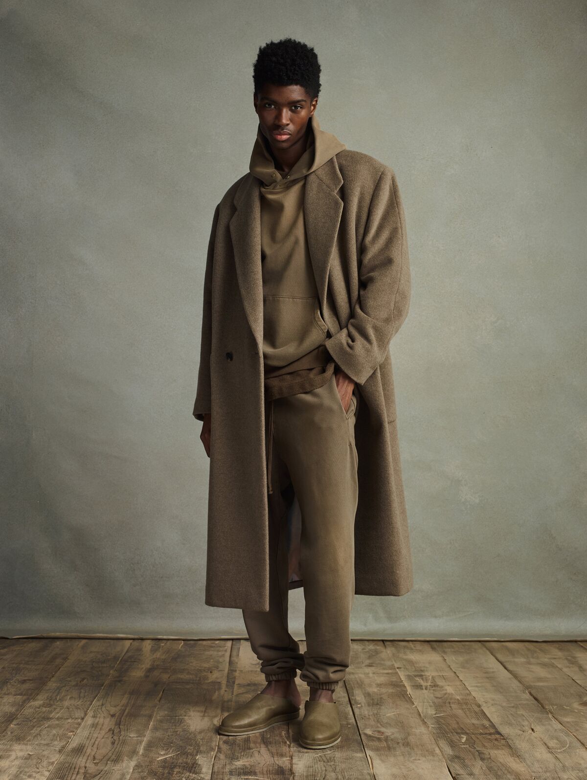 A model in sophisticated outerwear and footwear from Fear of God's seventh collection.