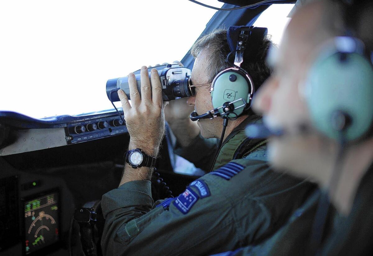 New Zealand Wing Cmdr. Rob Shearer takes a closer look at a site in the Indian Ocean during the search for Flight 370.