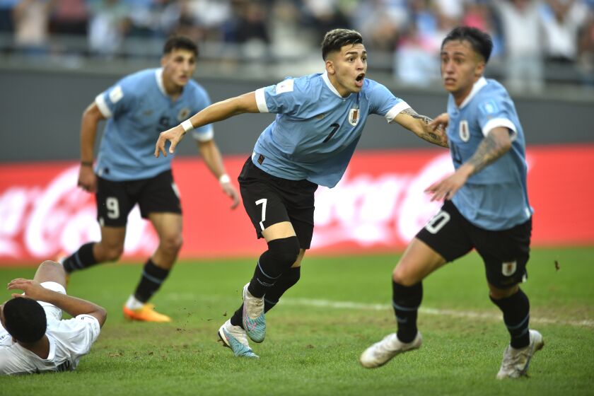 Uruguay's Anderson Duarte, center, celebrates scoring his side's opening goal against Israel during a FIFA U-20 World Cup semifinal soccer match at the Diego Maradona stadium in La Plata, Argentina, Thursday, June 8, 2023. (AP Photo/Gustavo Garello)