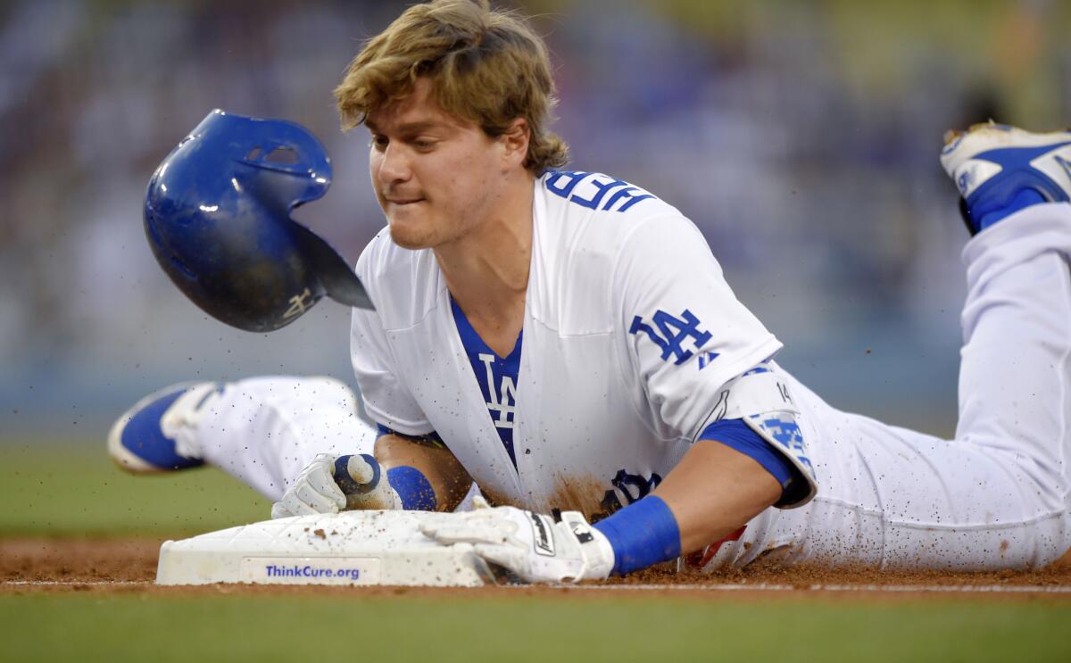 Los Angeles Dodgers' Enrique Hernandez dives back to first in an August game against the Cincinnati Reds.