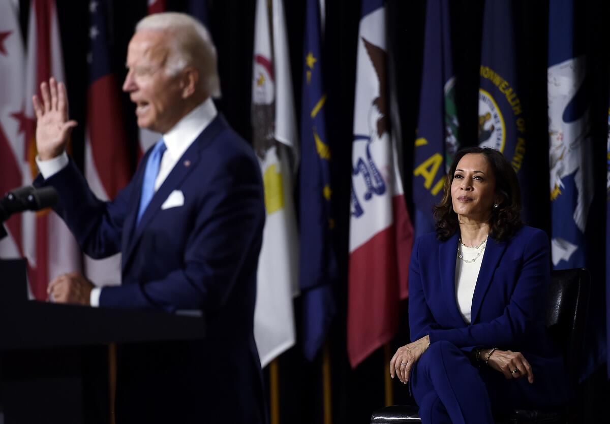 Kamala Harris watches Joe Biden introduce her as his running mate.