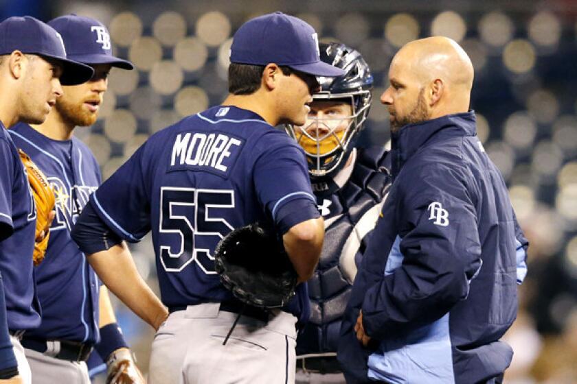 Rays starting pitcher Matt Moore (55) talks with a trainer after sustaining an injury during the fifth inning of a game against the Kansas City Royals on Monday.