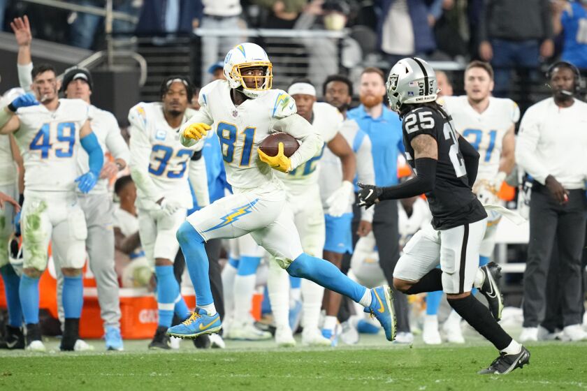 Los Angeles Chargers wide receiver Mike Williams (81) runs after catching a pass in overtime of an NFL football game against the Las Vegas Raiders, Sunday, Jan. 9, 2022, in Las Vegas. (AP Photo/Jeff Bottari)