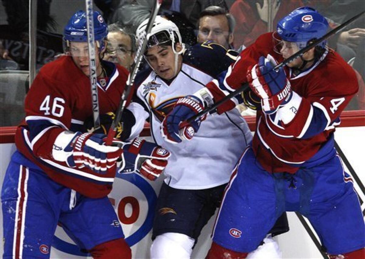 FILE - In this Feb. 26, 2008 file photo, Atlanta Thrashers' Eric Perrin get caught in between Montreal Canadiens' Andrei Kostitsyn, left, and his brother Sergei Kostitisyn, from Belarus, during second period NHL hockey action in Montreal. The Canadiens have traded winger Andrei Kostitsyn to Nashville, reuniting him with borther Sergei. The Canadiens received a second-round pick in 2013 and a conditional fifth-round selection ahead of the NHL's trade deadline on Monday, Feb. 27, 2012. (AP Photo/The Canadian Press, Paul Chiasson, File)