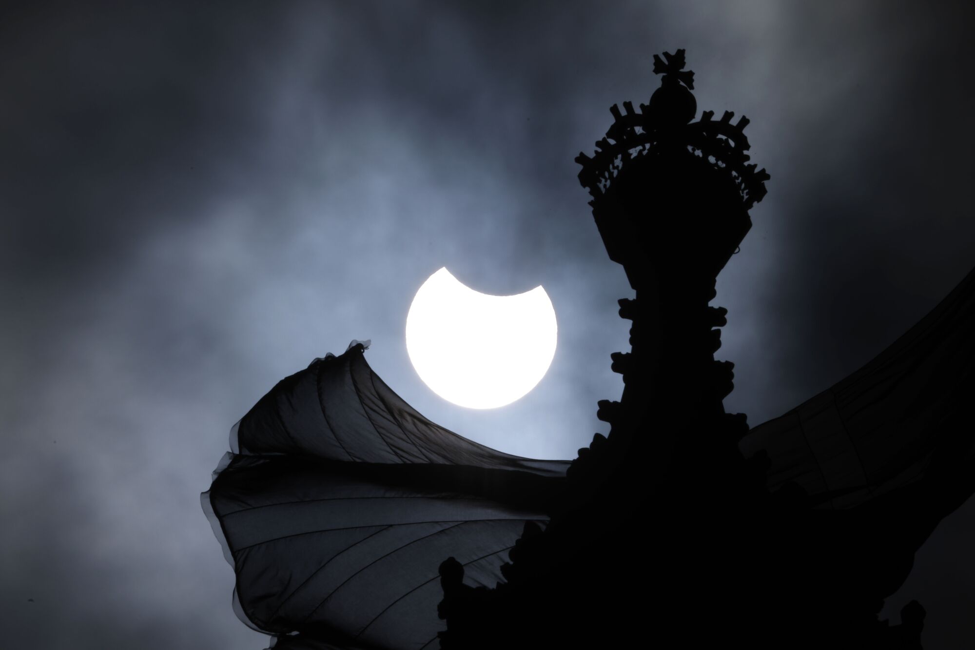 A partial solar eclipse is seen over the Houses of Parliament in London.