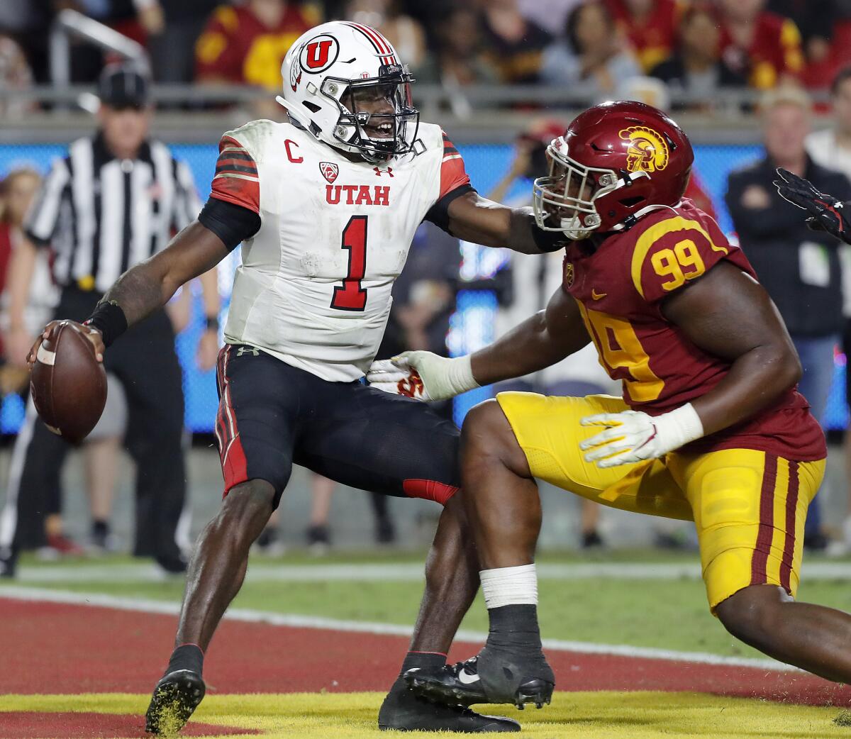 USC defensive lineman Drake Jackson closes in for a sack and safety of Utah quarterback Tyler Huntley in the fourth quarter at the Coliseum on Friday.
