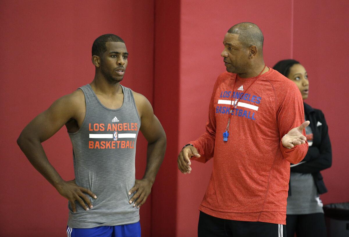 Clippers Coach Doc Rivers, right, speaks with guard Chris Paul during training camp in Las Vegas on Sept. 30.