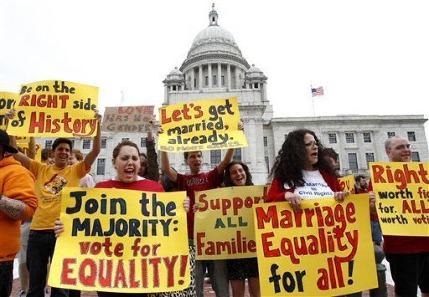 Protesters Jennifer DeSisto, of Barrington, R.I., front left, and Barbara Sawyer, of Warwick, R.I., front right, join with others in holding placards and chanting slogans during a rally in front of the Statehouse, in Providence, R.I., Tuesday, May 3, 2011, calling for marriage equality for gays and lesbians. (AP Photo/Steven Senne)
