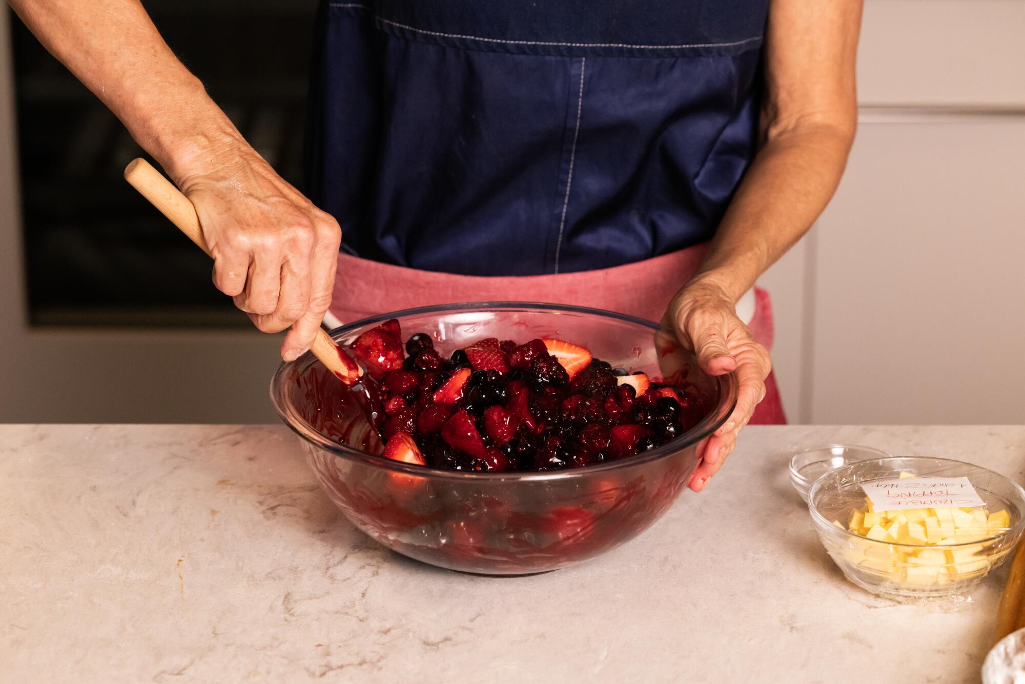 Mix a bowl of strawberries, blueberries and raspberries for a fruit cake in the kitchen of the Times.
