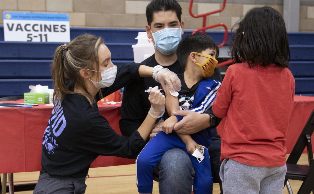 A 5-year-old gets vaccinated against COVID-19.