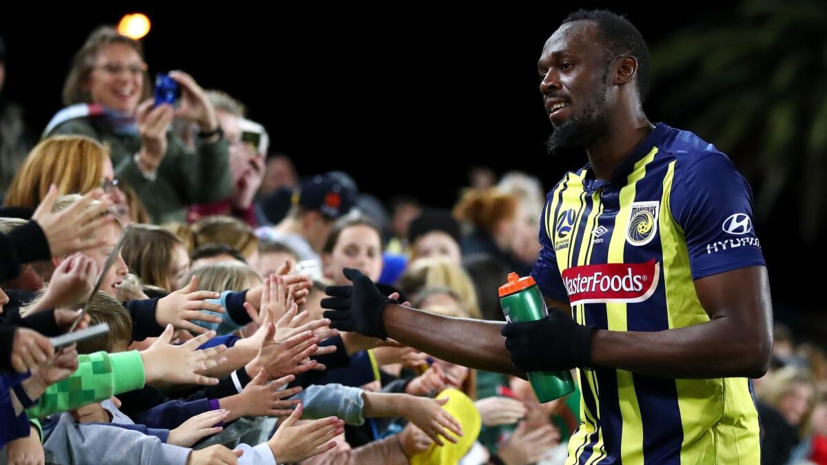 Usain Bolt greets Central Coast Mariners fans after his preseaon debut on Aug. 31 in Gosford, Australia.