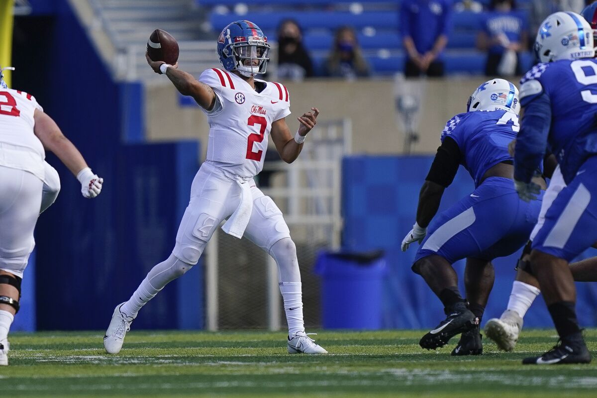 Mississippi quarterback Matt Corral (2) throws the ball during the first half of an NCAA college football game against Kentucky, Saturday, Oct. 3, 2020, in Lexington, Ky. (AP Photo/Bryan Woolston)