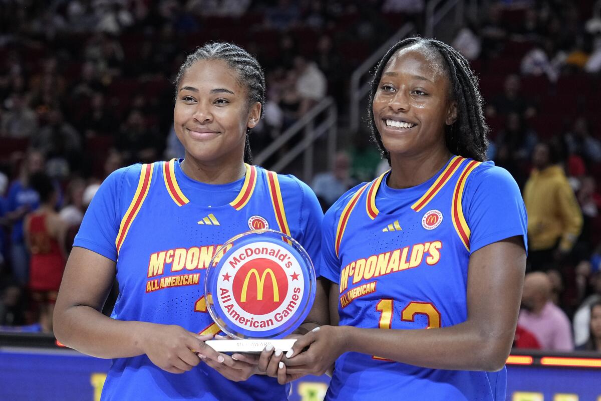 East forwards Sarah Strong, left, and Joyce Edwards are presented with the co-MVP award after the McDonald's All American girls' basketball game Tuesday, April 2, 2024, in Houston. (AP Photo/Kevin M. Cox)