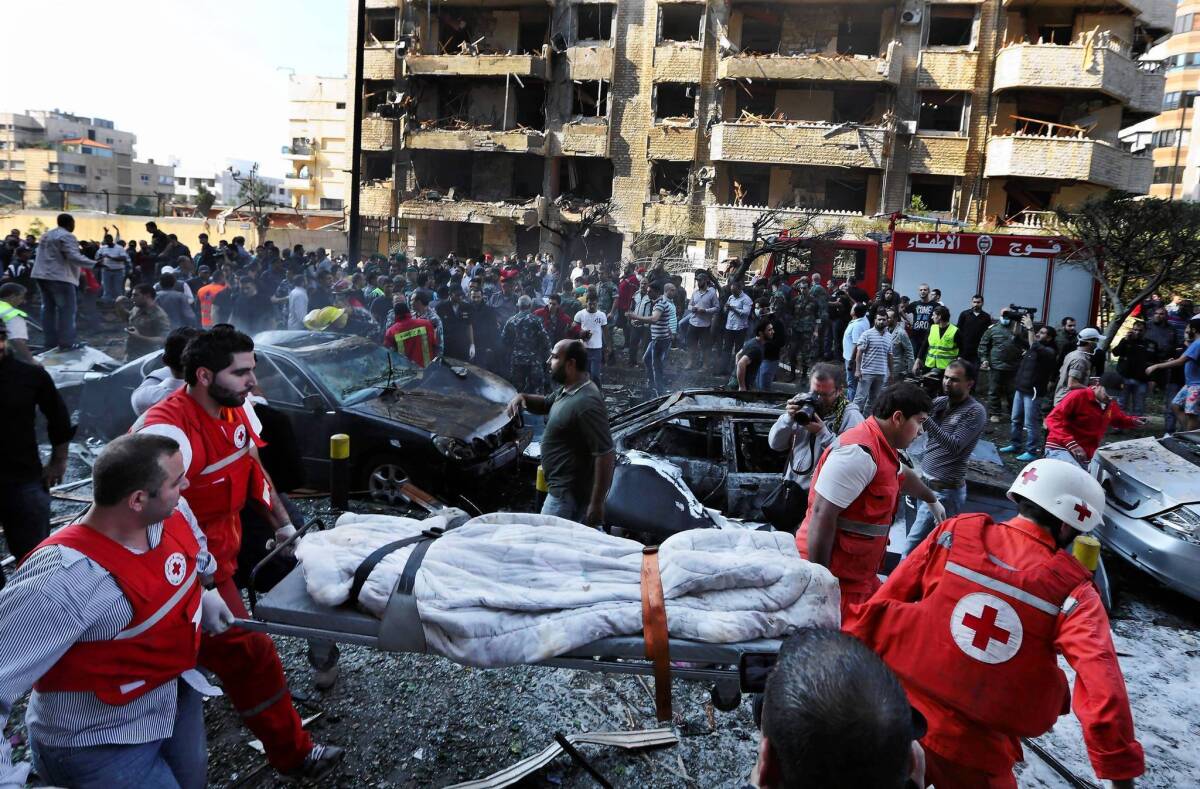 Lebanese Red Cross workers remove a body after the bombings at the Iranian Embassy in Beirut.