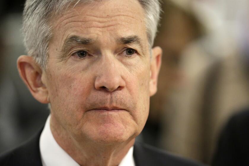 FILE- In this April 6, 2018, file photo, Federal Reserve Chairman Jerome Powell listens as he tours mHUB during a visit to Chicago. The Federal Reserve releases minutes from its most recent policymakersâ meeting on Wednesday, May 23. (AP Photo/Charles Rex Arbogast, File)