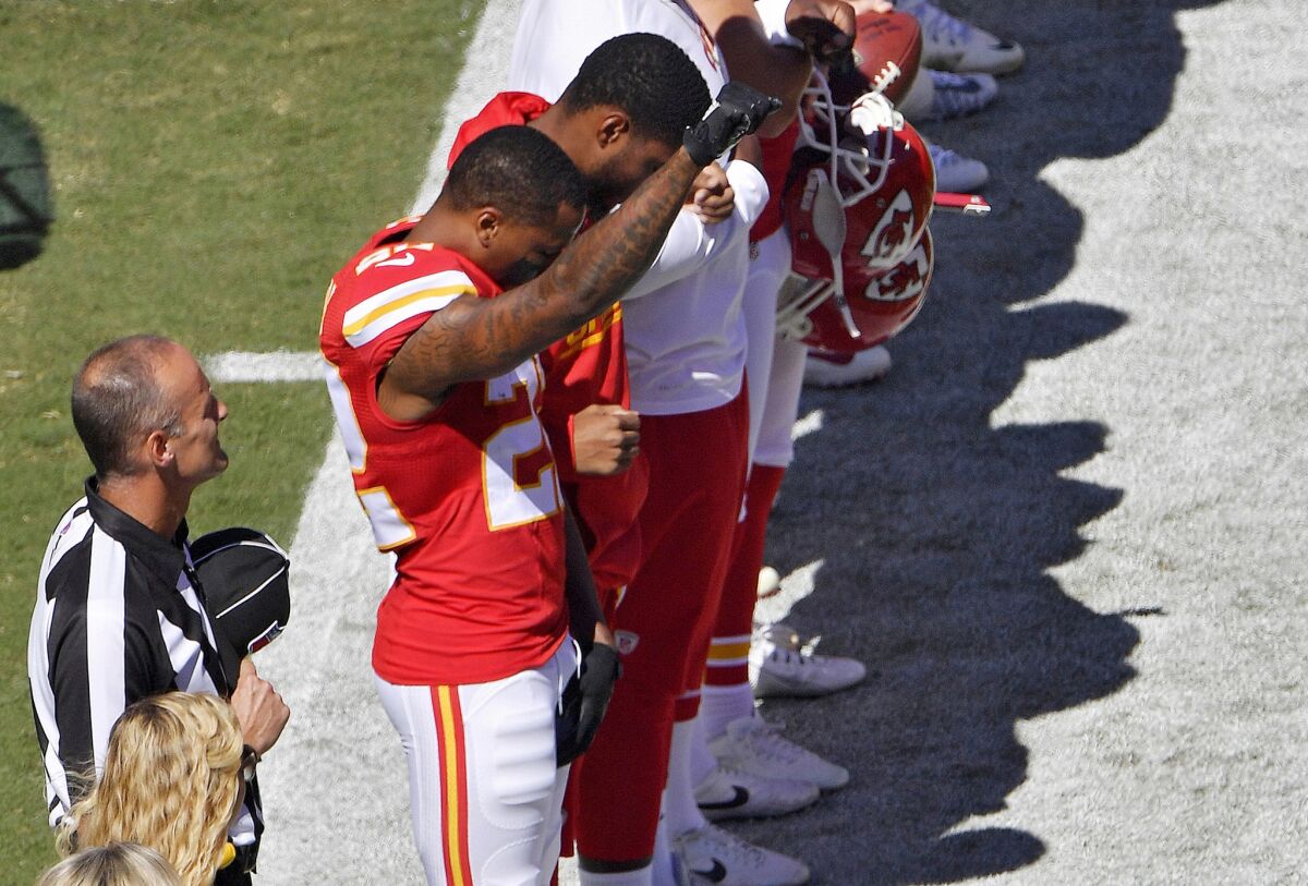 Chiefs cornerback Marcus Peters raises a fist in the air during the national anthem before a game against the San Diego Chargers.
