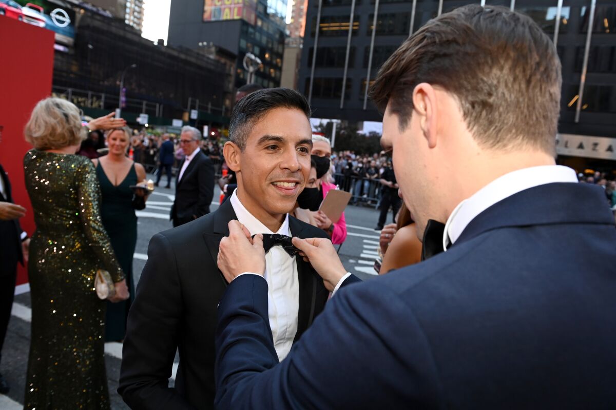 Matthew López gets his bow tie fixed by a friend on the red carpet at the Tony Awards.