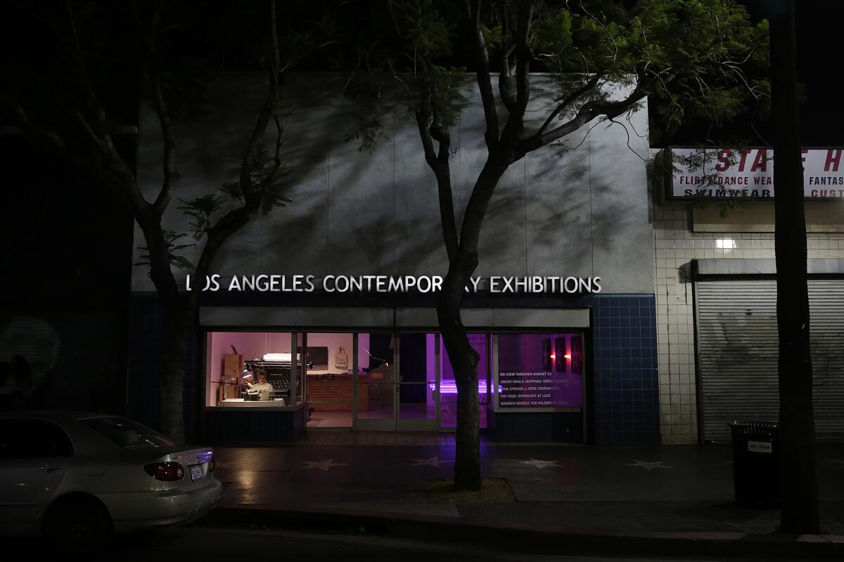 A lone passerby watches artist Tim Youd retype John Rechy's "City of Night" in its entirety.