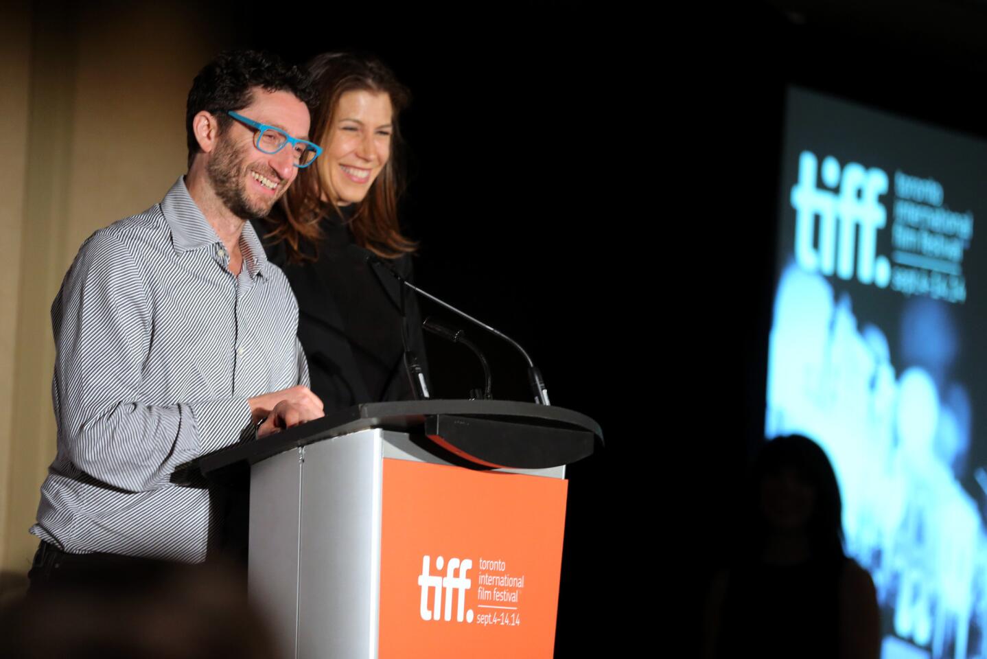 Executive Noah Segal and Laurie May accept the Grolsch People's Choice Award on behalf of "The Imitation Game" during the TIFF Awards Brunch at Intercontinental Hotel in Toronto.
