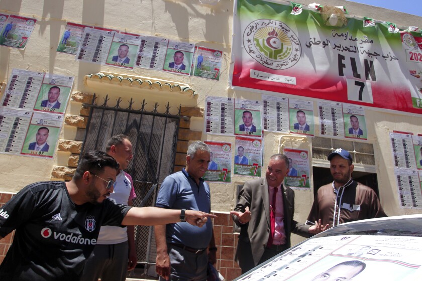 Men argue by electoral posters in Ain Ouessara, 190 kilometers (118 miles) from Algiers, Thursday, June 10, 2021. In addition to the traditional parties, dozens of independent candidates have decided to take part in the legislative elections on June 12, that the government organized earlier than expected under a new system meant to weed out corruption and open voter rolls — a major step in President Abdelmadjid Tebboune's promise of a "new Algeria." (AP Photo/Fateh Guidoum)
