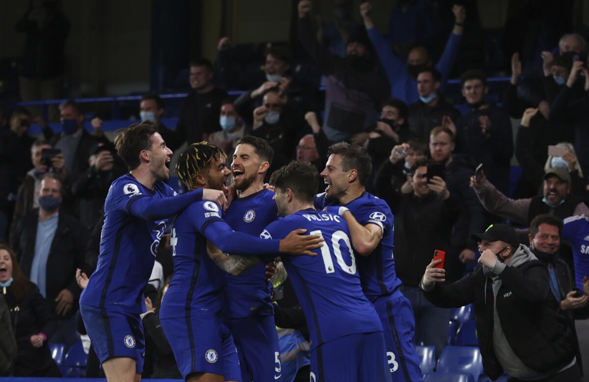 Chelsea's Jorginho celebrates with teammates after scoring his side's second goal from penalty during the English Premier League soccer match between Chelsea and Leicester City at Stamford Bridge Stadium in London, Tuesday, May 18, 2021. (Catherine Ivill/Pool via AP)