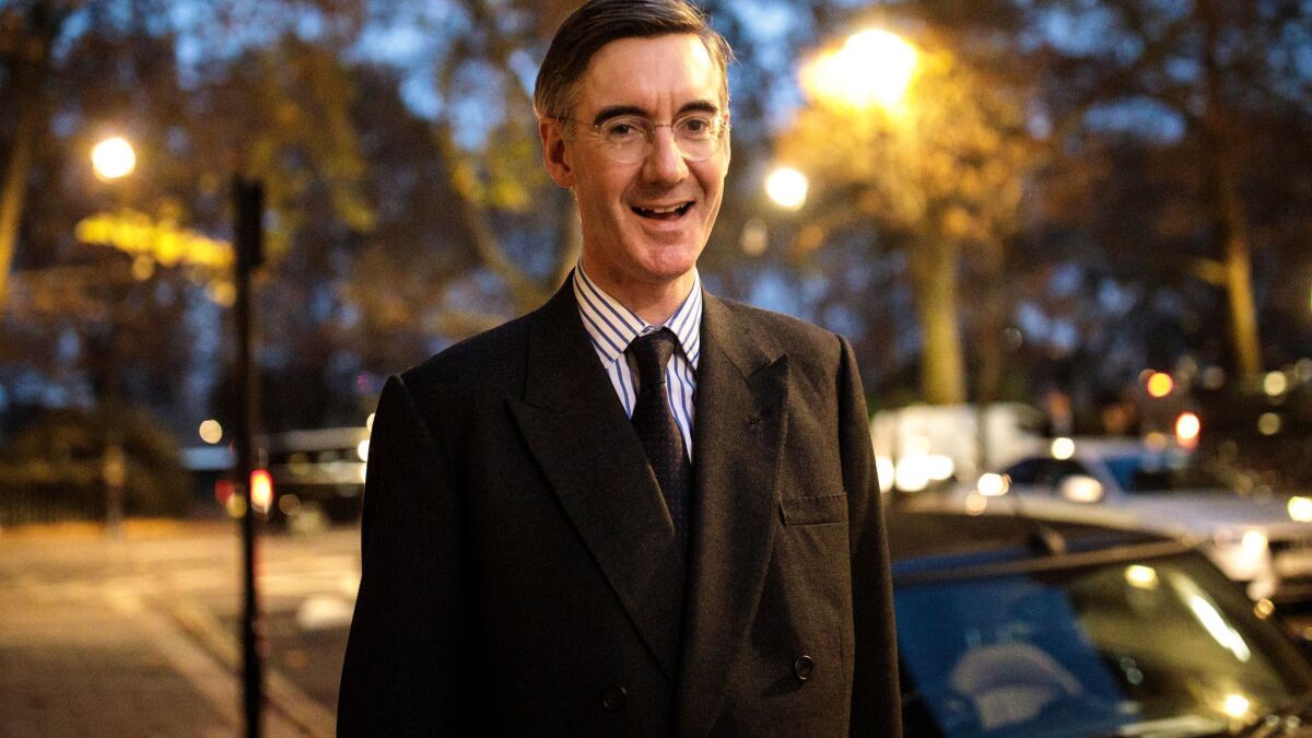 Conservative lawmaker Jacob Rees-Mogg walks in Westminster after submitting a letter calling for a vote of no-confidence in Prime Minister Theresa May.