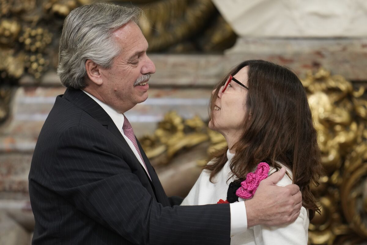 President Alberto Fernandez embraces his new Economy Minister Silvina Batakis at the government house in Buenos Aires, Argentina, Monday, July 4, 2022. Batakis will replace Martín Guzmán who quit unexpectedly Saturday, posting a seven-page resignation letter on Twitter. (AP Photo/Natacha Pisarenko)