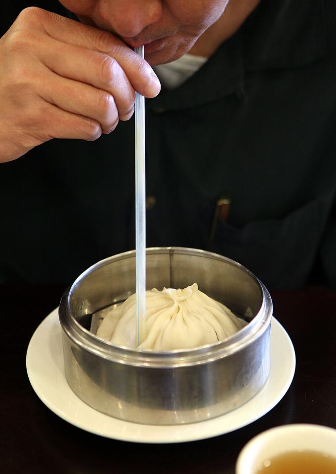 A soup dumpling the size of a softball requires a straw at Wang Xing Ji.