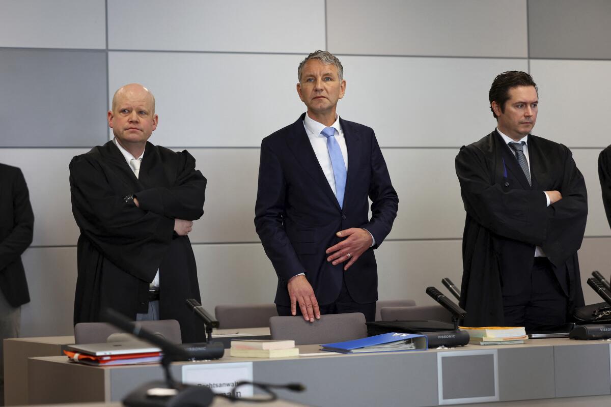 German far-right politician of the Alternative for Germany (AfD) Bjoern Hoecke, centre, attends his trial in the state court in Halle, Germany, Thursday, April 18, 2024. Bjoern Hoecke, goes on trial at the state court in Halle on charges related to his alleged use in a 2021 speech of a slogan used by the Nazis' SA stormtroopers. (Fabrizio Bensch/Pool via AP)