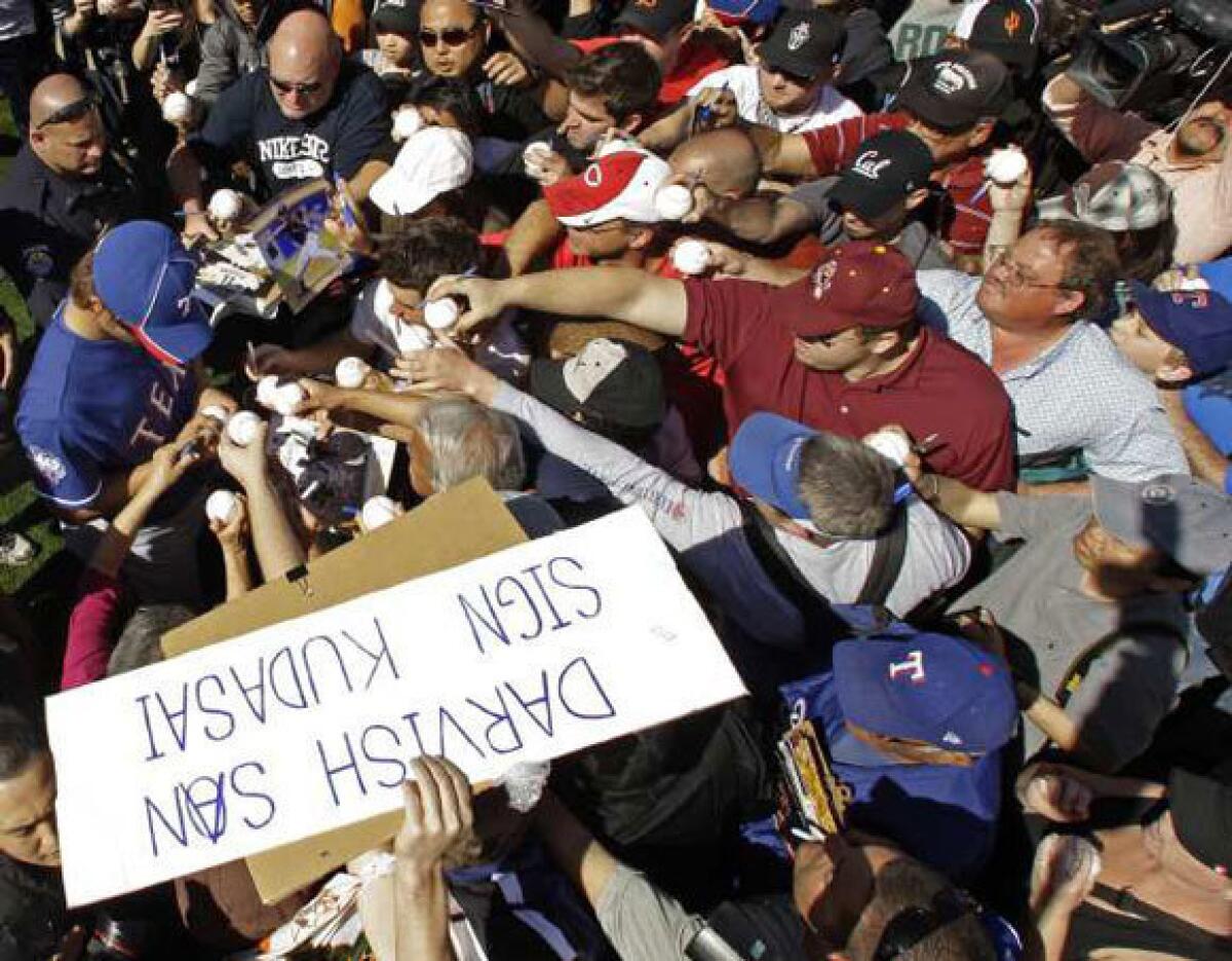 A crowd surrounds Yu Darvish as he signs autographs last week.