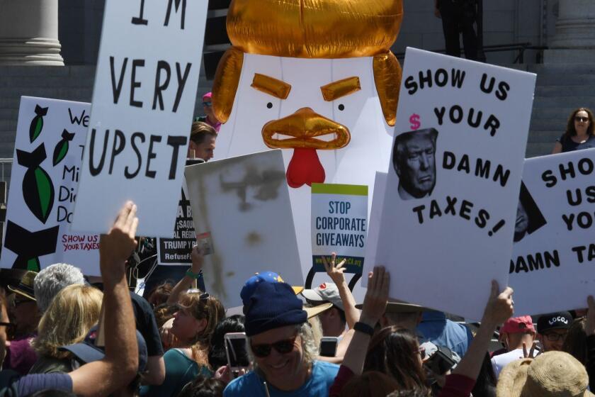 Protestors take part in the "Tax March" calling on US President Donald Trump to release his tax records in Los Angeles, California on April 15, 2017. / AFP PHOTO / Mark RALSTONMARK RALSTON/AFP/Getty Images ** OUTS - ELSENT, FPG, CM - OUTS * NM, PH, VA if sourced by CT, LA or MoD **