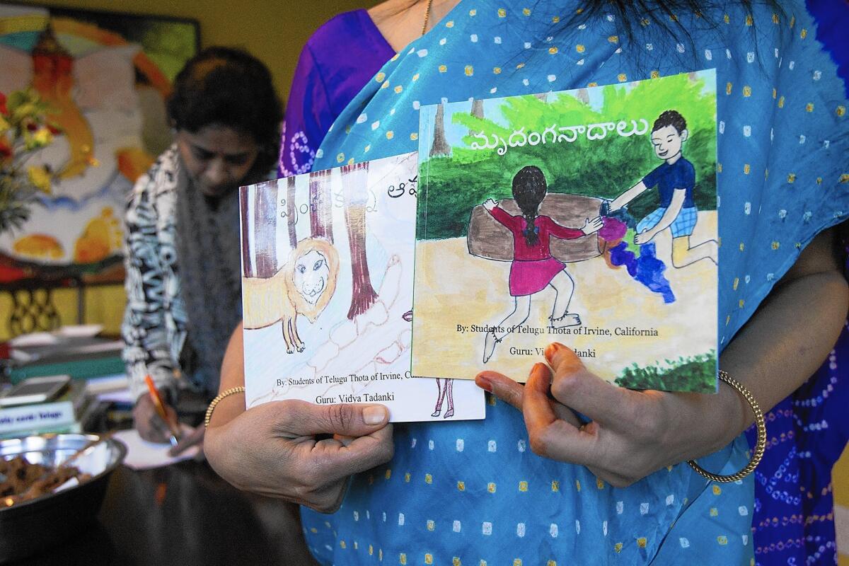 Vidya Tandanki displays books created by students at her in-home Telugu Thota school in Irvine.