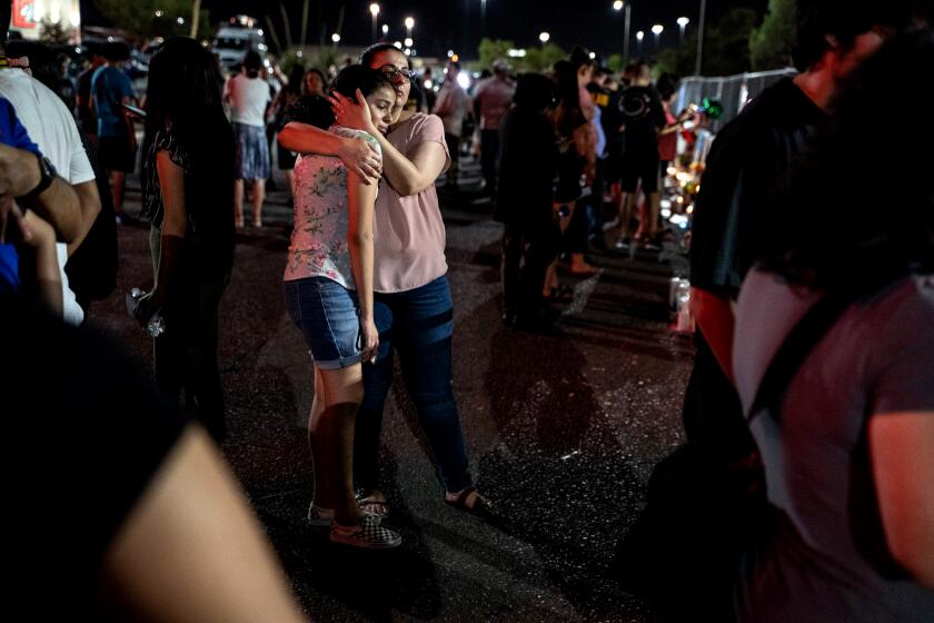 TOPSHOT - Locals of El Paso visit the memorial for shooting victims at the Cielo Vista Mall Walmart in El Paso, Texas on August 8, 2019. - The El Paso community is still reeling from the trauma of the mass shooting which left 22 dead and dozens injured. (Photo by Paul Ratje / AFP)PAUL RATJE/AFP/Getty Images ** OUTS - ELSENT, FPG, CM - OUTS * NM, PH, VA if sourced by CT, LA or MoD **