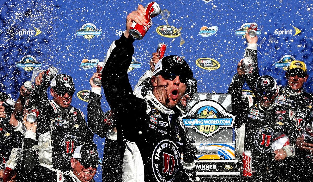 Kevin Harvick celebrates in victory lane after winning the NASCAR Sprint Cup Series CampingWorld.com 500 at Phoenix International Raceway on Sunday.
