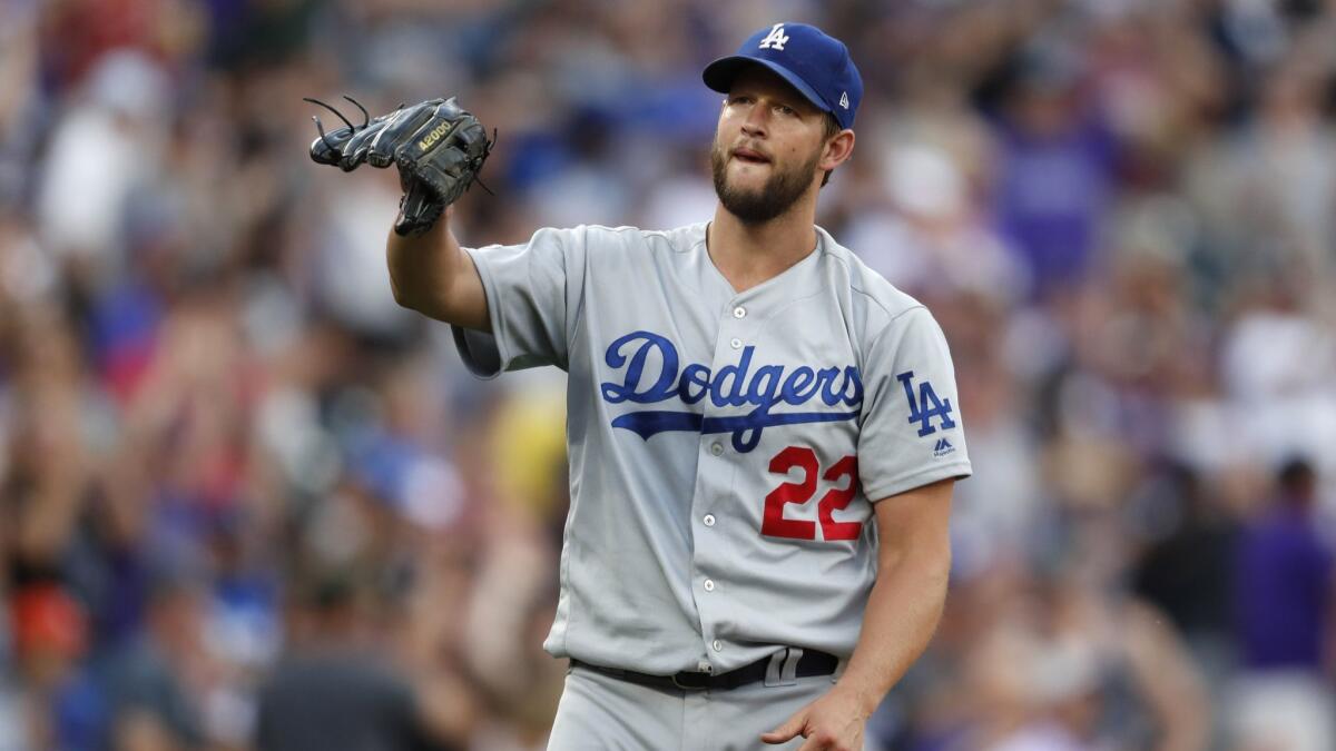 Los Angeles Dodgers pitcher Clayton Kershaw waits for a new ball after giving up a two-run homer to the Colorado Rockies' Charlie Blackmon in the third inning Saturday night.