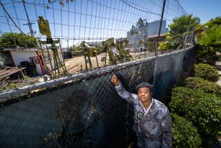 Los Angeles, CA - August 21: Sim Bilal is a young climate change activist who has written a first-person essay and is photographed next to pumps at an oil field in Los Angeles Wednesday, Aug. 21, 2024. (Allen J. Schaben / Los Angeles Times)