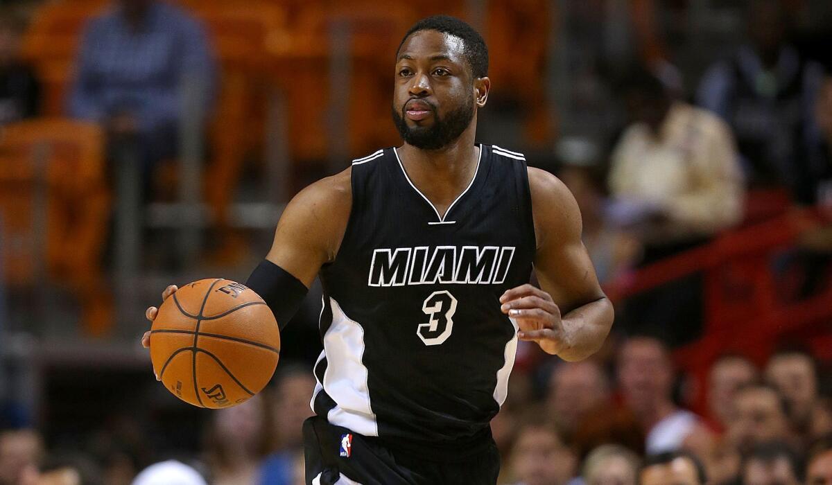 Heat guard Dwyane Wade brings the ball up the court against the Pacers during a game Friday night in Miami.