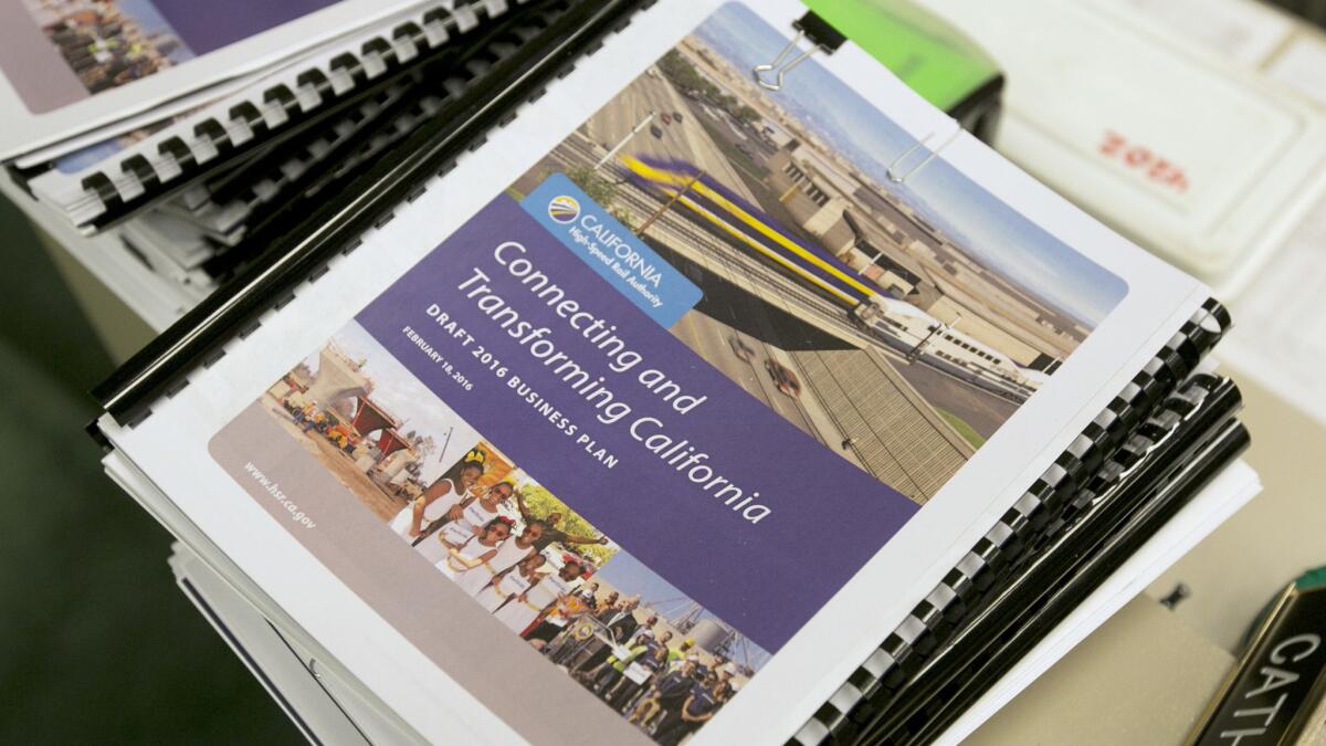 Copies of the proposed business plan for the California high-speed rail authority are seen at a hearing in Sacramento on March 28.