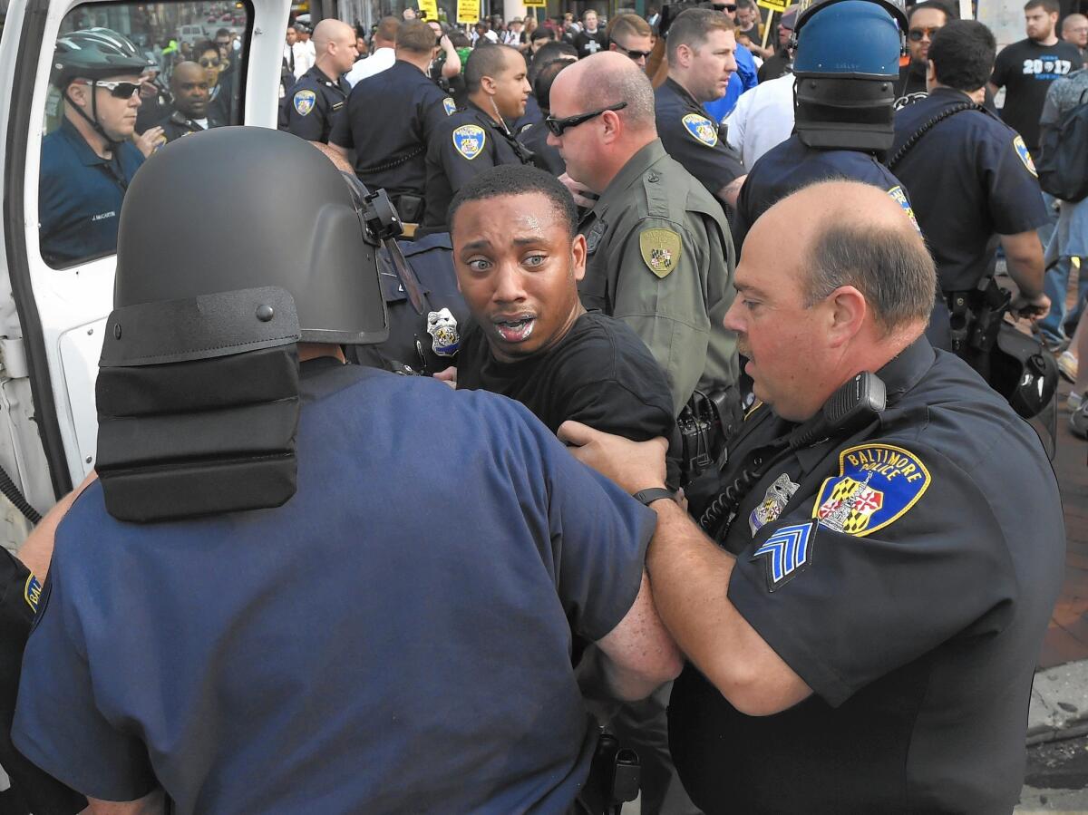Kwame Rose is detained by police on Sept. 2 as protesters rallied outside the Baltimore courthouse during the first court hearing for six police officers charged in the death of Freddie Gray.